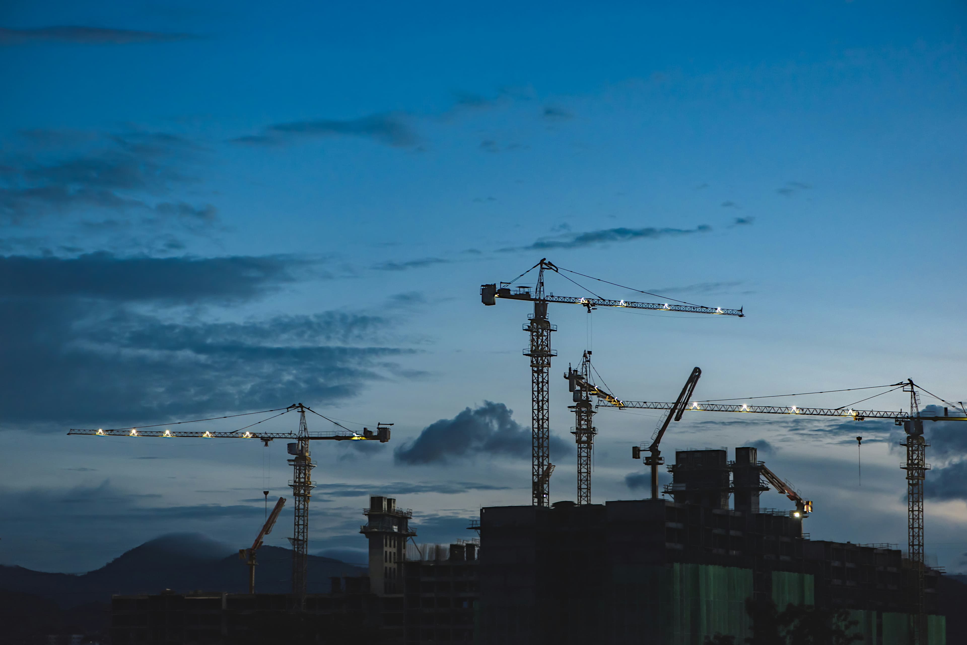 Large-scale industrial construction site with cranes